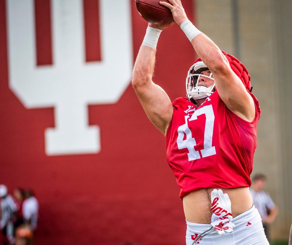 Indiana's Micah McFadden (47) goes up for an interception during practice on the field outside the Mellencamp Pavilion at Indiana University on Friday, August 6, 2021.