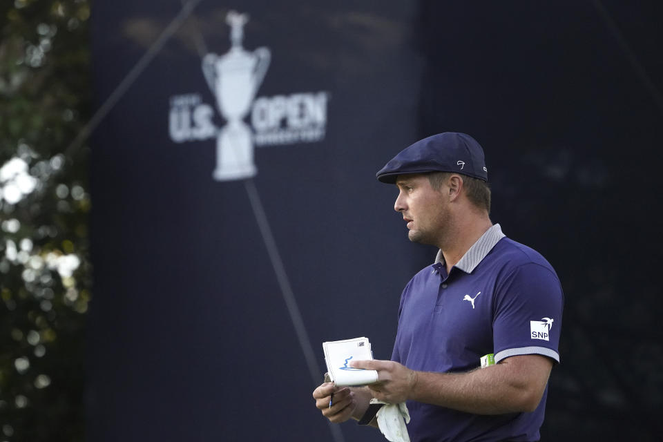 Bryson DeChambeau, of the United States, makes notes on the 16th green during the third round of the US Open Golf Championship, Saturday, Sept. 19, 2020, in Mamaroneck, N.Y. (AP Photo/John Minchillo)