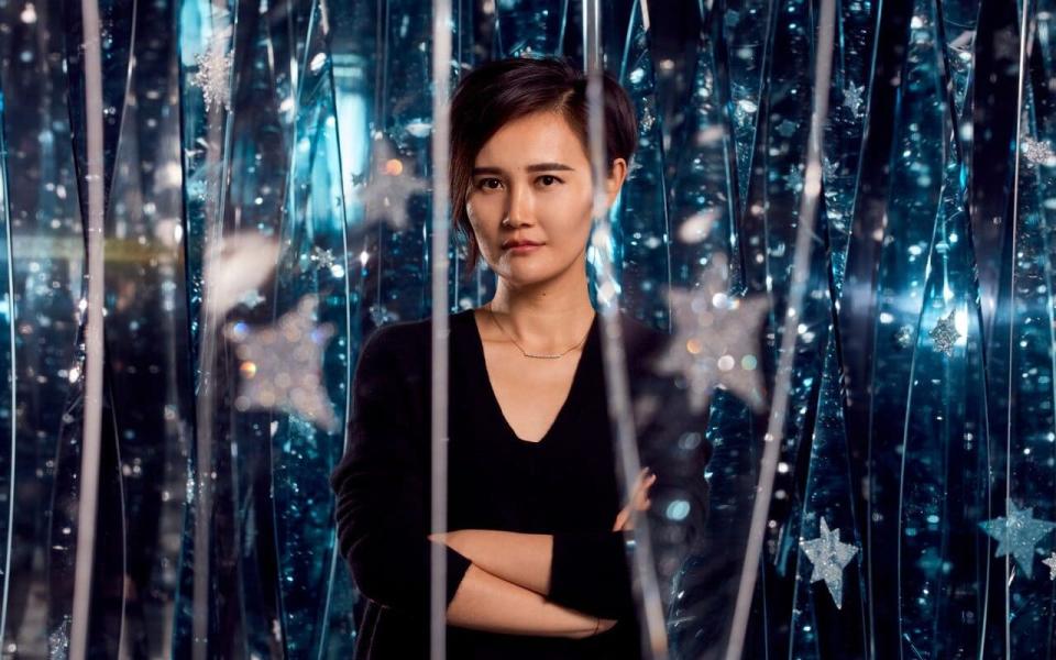 Shanghai-born installation artist Juju Wang, one of the Swarovski laureates, with her work at Art Basel, which opens this week. In her work, moving crystal panels mimic the natural phenomenon of sunlight reflected on water.  - Mark cocksedge