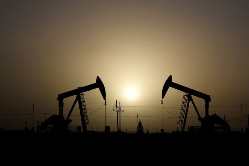 FILE PHOTO: Pump jacks operate at sunset in Midland, Texas