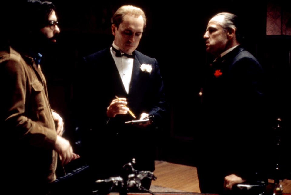 THE GODFATHER, director Francis Ford Coppola, Robert Duvall, Marlon Brando on set, 1972 (The Everett Collection)