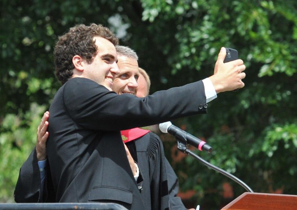 Nolan Simmons, left, takes a selfie with Thayer Academy Head of School Chris Fortunato after receiving his diploma Saturday, June 11, 2022.
