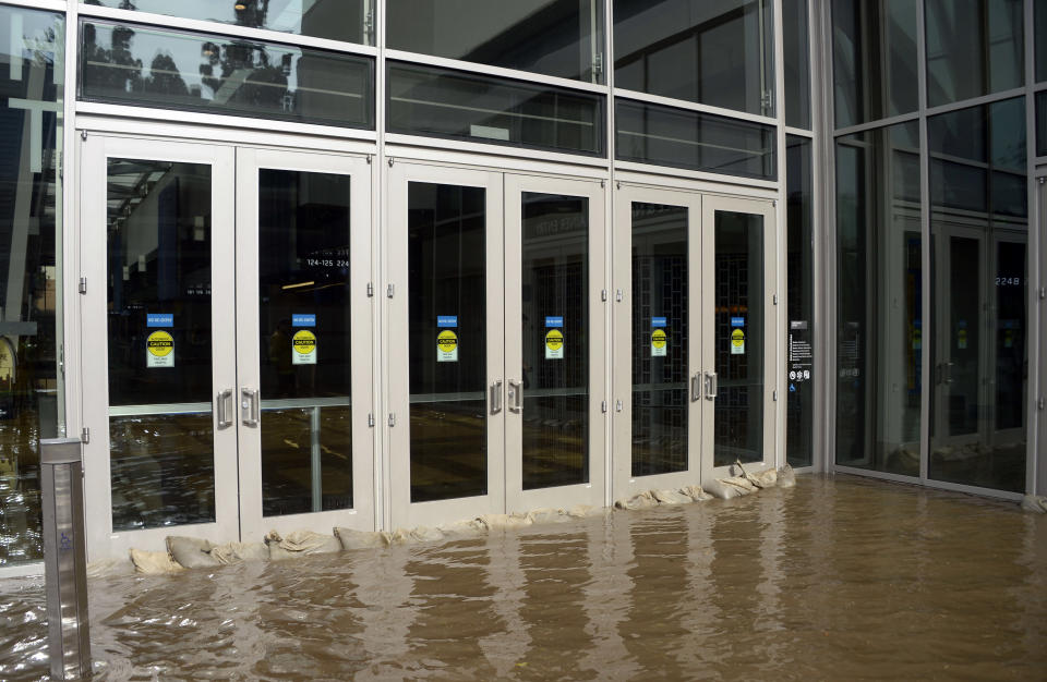 Sandbags fail to stop water from entering the main doors of Pauley Pavilion, home of UCLA basketball, on the UCLA campus after flooding from a broken 30-inch water main under nearby Sunset Boulevard inundated a large area of the campus in the Westwood section of Los Angeles, Tuesday, July 29, 2014. The 30-inch (75-centimeter) 93-year-old pipe that broke made a raging river of the street and sent millions of gallons (liters) of water across the school's athletic facilities, including the famed floor of Pauley Pavilion, the neighboring Wooden Center and the Los Angeles Tennis Center, and a pair of parking structures that took the brunt of the damage. (AP Photo/Mike Meadows)