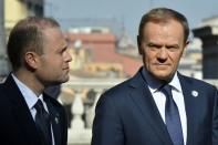 EU President Donald Tusk (R) speaks with Malta's prime minister Joseph Muscat ahead of a special summit of EU leaders to mark the 60th anniversary of the bloc's founding Treaty of Rome, on March 25, 2017 at Rome's Piazza del Campidoglio