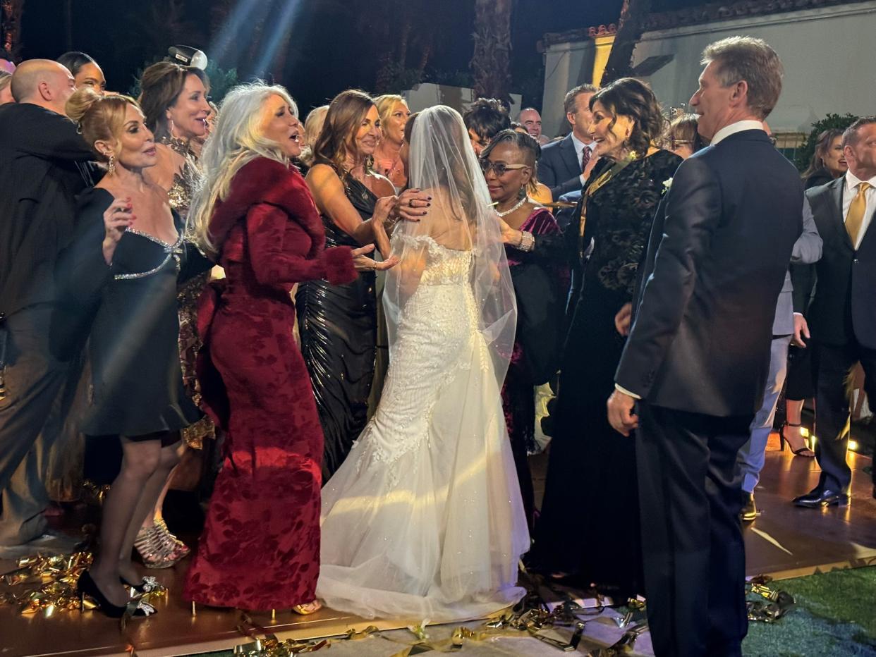 Just after getting married to the Golden Bachelor, Theresa Nist is surrounded by friends and former contestants from the show. Nist and runner-up Leslie Fhima appear to be speaking warmly to each other.