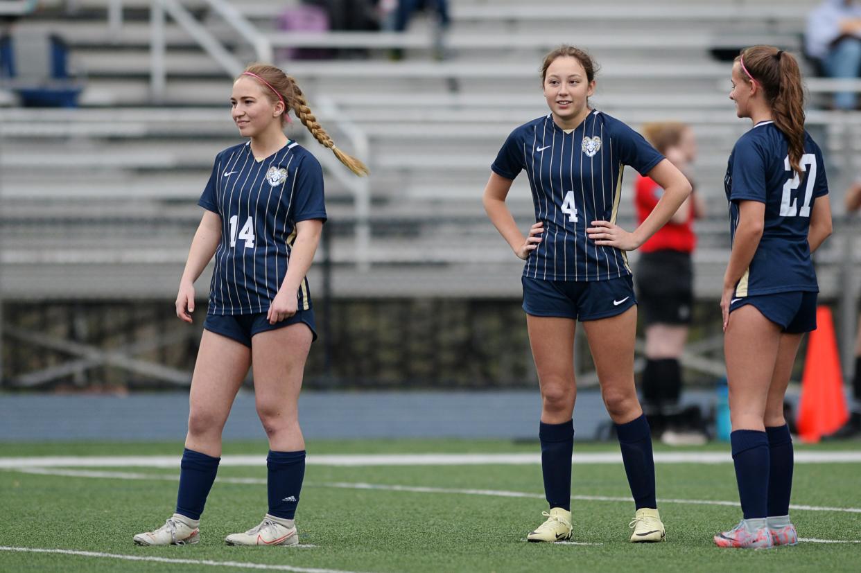 Roberson junior, Elena Loli, center, warms up with her teammates before the game against Reynolds, April 10, 2024.