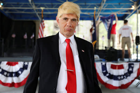 Bobby Blaze, dressed as U.S. President Donald Trump, poses during a rally in Mandeville, Louisiana U.S., February 27, 2017. REUTERS/Shannon Stapleton