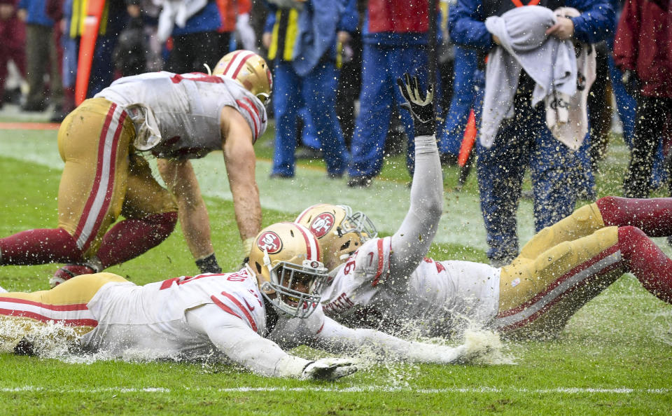 49ers players used the wet field as a Slip-N-Slide to celebrate, but Richard Sherman was just glad he escaped the game without an injury. (Photo by Jonathan Newton / The Washington Post via Getty Images)