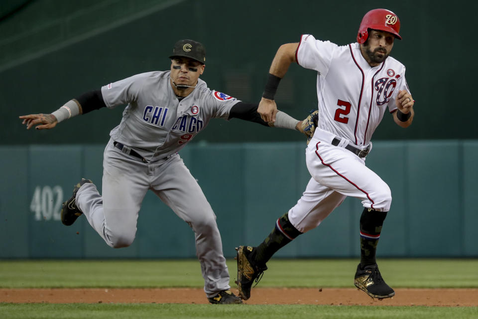 Washington Nationals' Adam Eaton (2) is tagged out by Chicago Cubs shortstop Javier Baez after trying to steal second during the third inning of a baseball game Saturday, May 18, 2019, in Washington. (AP Photo/Andrew Harnik)