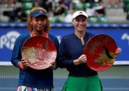 Tennis - Pan Pacific Open Women's Singles Final match - Ariake Coliseum, Tokyo, Japan - 25/09/16. Caroline Wozniacki of Denmark, flanked by second-placed Naomi Osaka of Japan, holds a winning plate during an awarding ceremony after winning the final match. REUTERS/Issei Kato