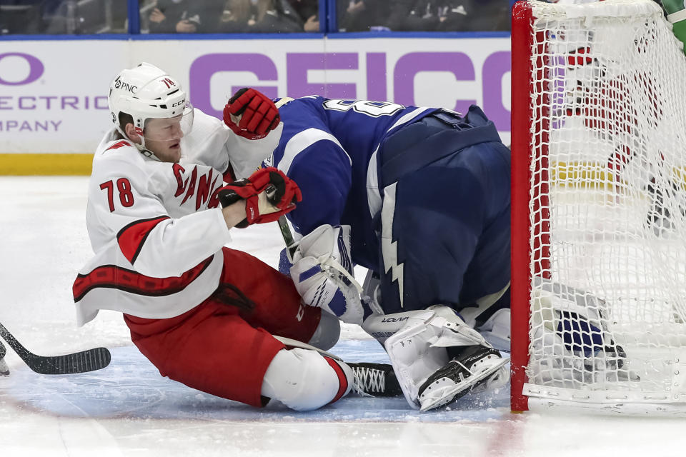 Carolina Hurricanes' Steven Lorentz (78) crashes into Tampa Bay Lightning goaltender Andrei Vasilevskiy during the first period of an NHL hockey game Tuesday, April 20, 2021, in Tampa, Fla. (AP Photo/Mike Carlson)