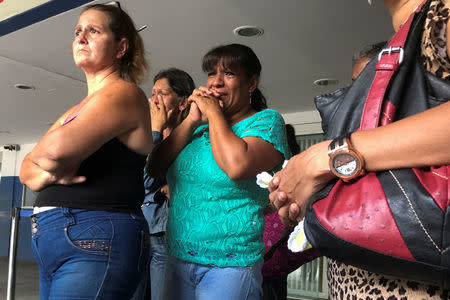 Relatives of people who died at Los Cotorros club when a person activated a tear gas grenade inside, according to Venezuela's interior minister Nestor Reverol, react outside the Perez Carreno hospital in Caracas Venezuela June 16, 2018. REUTERS/Marco Bello