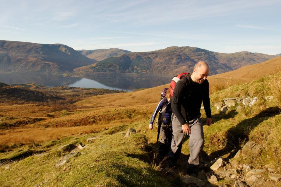 Climbers approaching the summit of Ben Lomond in autumn (Getty/iStock)