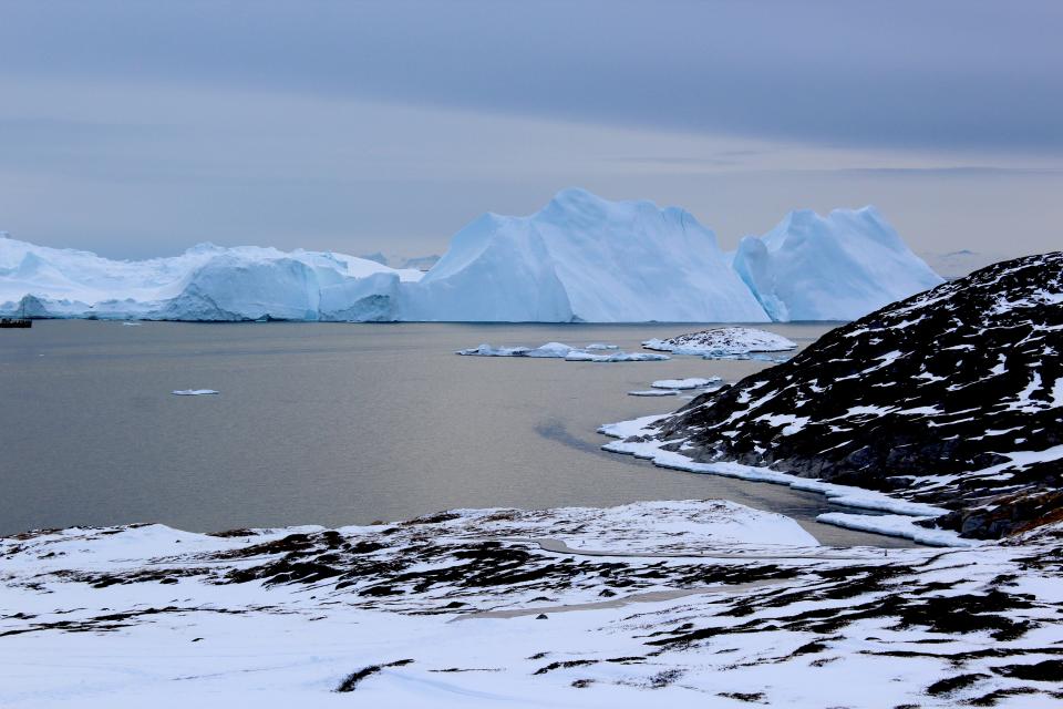 Icebergs near Greenland form from ice that has broken off from glaciers on the island. A new study shows that the glaciers are losing ice rapidly enough that, even if global warming were to stop, Greenland's glaciers would continue to shrink.