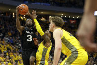 Butler's Kamar Baldwin (3) drives the basket against Marquette defenders during the second half of an NCAA college basketball game Sunday, Feb. 9, 2020, in Milwaukee. (AP Photo/Aaron Gash)