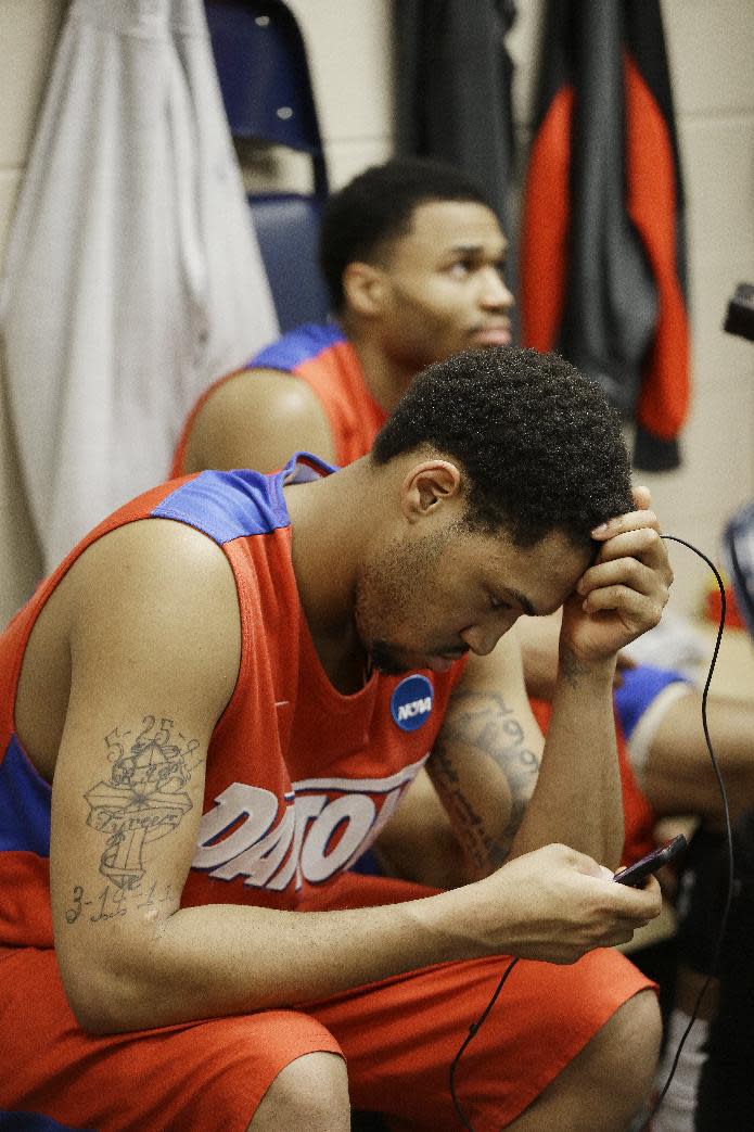 Dayton's Jalen Robinson, foreground and Vee Sanford sit in the locker room after the second half in a regional final game against Florida at the NCAA college basketball tournament, Saturday, March 29, 2014, in Memphis, Tenn. Florida won 62-52. (AP Photo/Mark Humphrey)