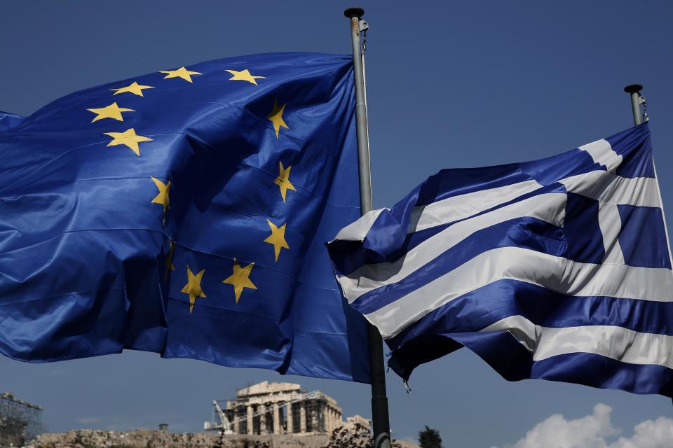 An EU and a Greek flag fly in front of the ancient Parthenon temple, in Athens, on Wednesday, April 9, 2014. Greece announced Wednesday it was returning to international bond markets for the first time in four years amid growing signs of confidence in the country at the forefront of the European debt crisis. (AP Photo/Petros Giannakouris)