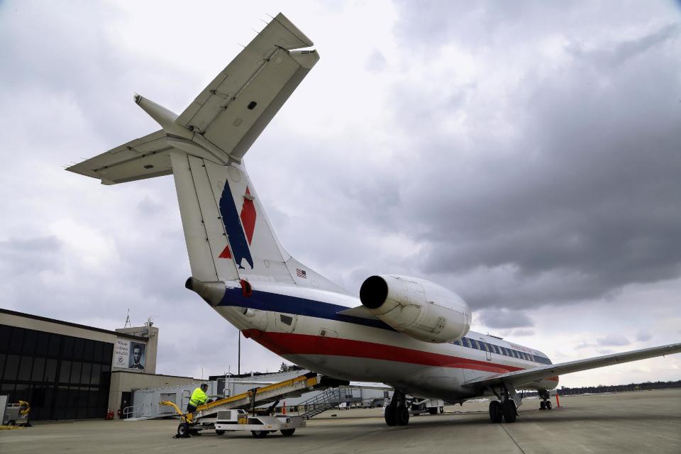In this March 12, 2013 photo, baggage handlers unload an American Eagle jet after it landed at the Abraham Lincoln Capital Airport in Springfield, Ill. The airport is one of nearly 240 small airports around the country that will likely shut down their air traffic control towers under federal budget cuts, stripping away a layer of safety during takeoffs and landings and leaving many pilots to manage the most critical stages of flight on their own. (AP Photo/Seth Perlman)