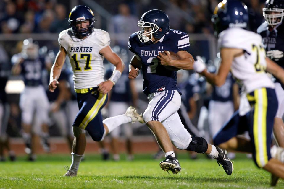 Fowler's Nolan Stump (2) runs against Pewamo-Westphalia's Troy Wertman (17) to set up the game-winning touchdown, Friday, Sept. 23, 2022, in Fowler. Fowler won 20-16.