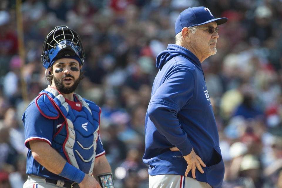 Texas Rangers manager Bruce Bochy, right, waits for a new pitcher as Austin Hedges stands by during the fourth inning of a baseball game against the Cleveland Guardians in Cleveland, Sunday, Sept. 17, 2023. (AP Photo/Phil Long)