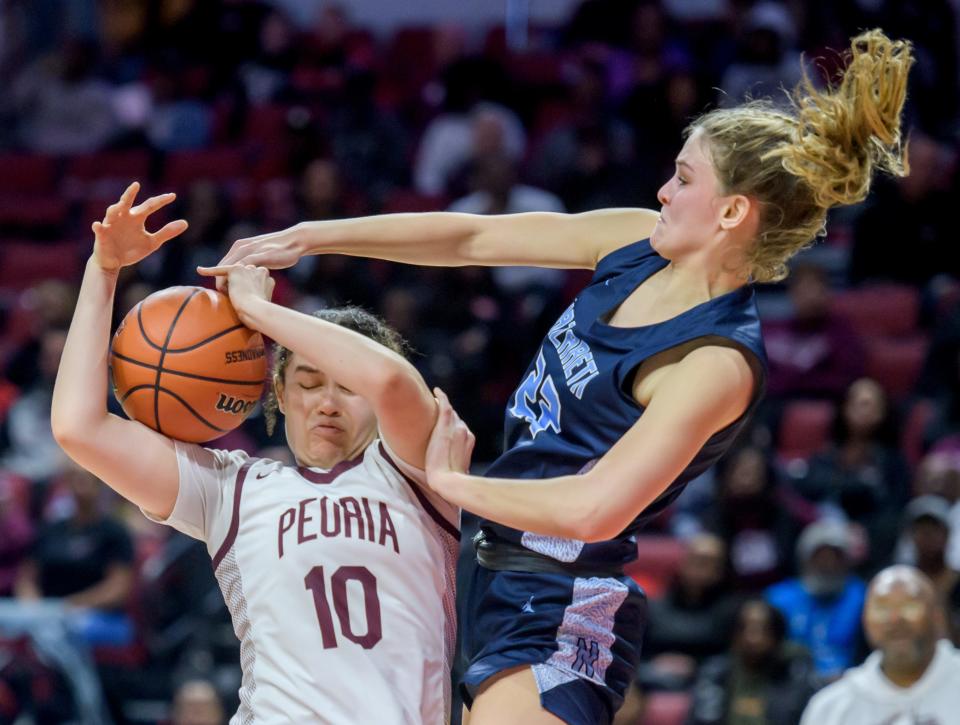 Peora's Denali Craig-Edwards takes a foul from Nazareth Academy's Grace Carstensen in the second half of the Class 3A state semifinals Friday, Mar. 3, 2023 at CEFCU Arena in Normal. The Lions fell to the Roadrunners 48-35.