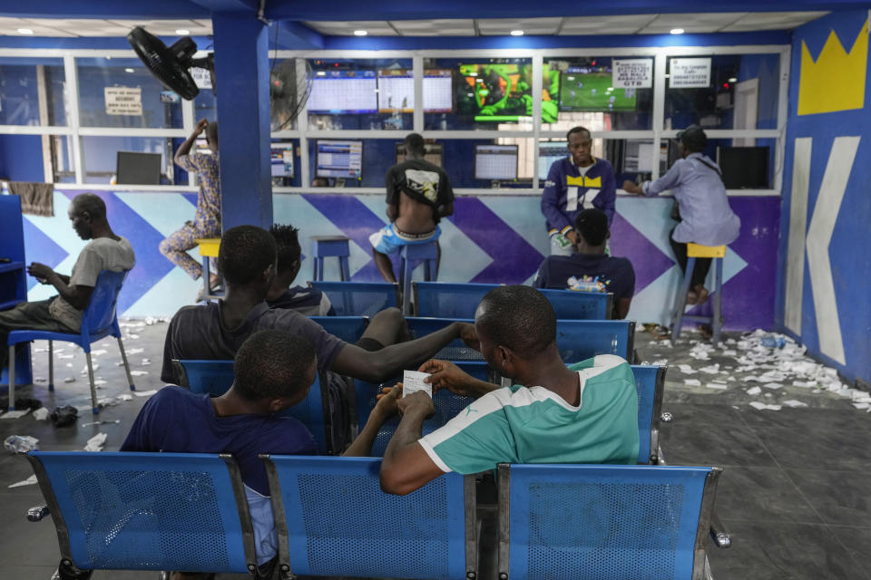 A man plays a world cup betting game at a sports betting shop in Lagos, Nigeria, Monday, Dec. 5, 2022. Although sports betting is a global phenomenon and a legitimate business in many countries, the stakes are high on the continent of 1.3 billion people because of lax or non-existent regulation, poverty and widespread unemployment. (AP Photo/Sunday Alamba)