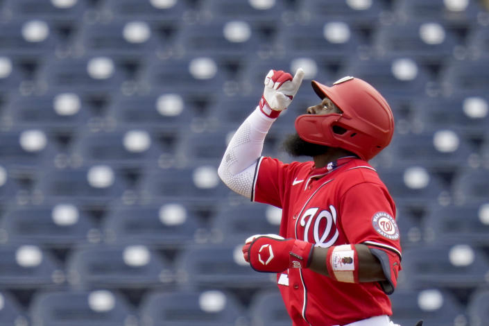 Washington Nationals' Josh Harrison points after hitting a solo home run during the third inning of a spring training baseball game against the Houston Astros Monday, March 1, 2021, in West Palm Beach, Fla. (AP Photo/Jeff Roberson)