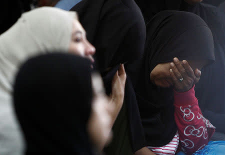 Family members wait for news of their loved ones outside religious school Darul Quran Ittifaqiyah after a fire broke out in Kuala Lumpur, Malaysia September 14, 2017. REUTERS/Lai Seng Sin