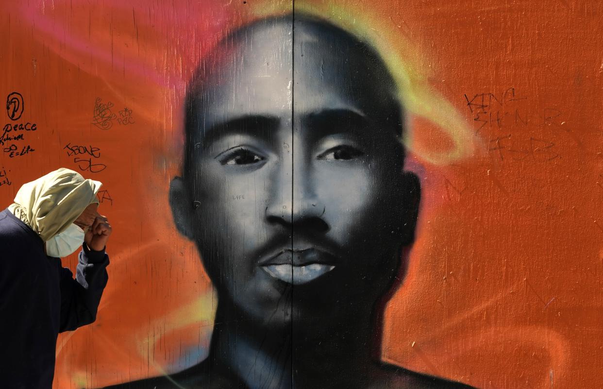 A man walks by a mural of the late rapper Tupac Shakur in the Harlem area of  New York City on May 5, 2020. (AFP via Getty Images)