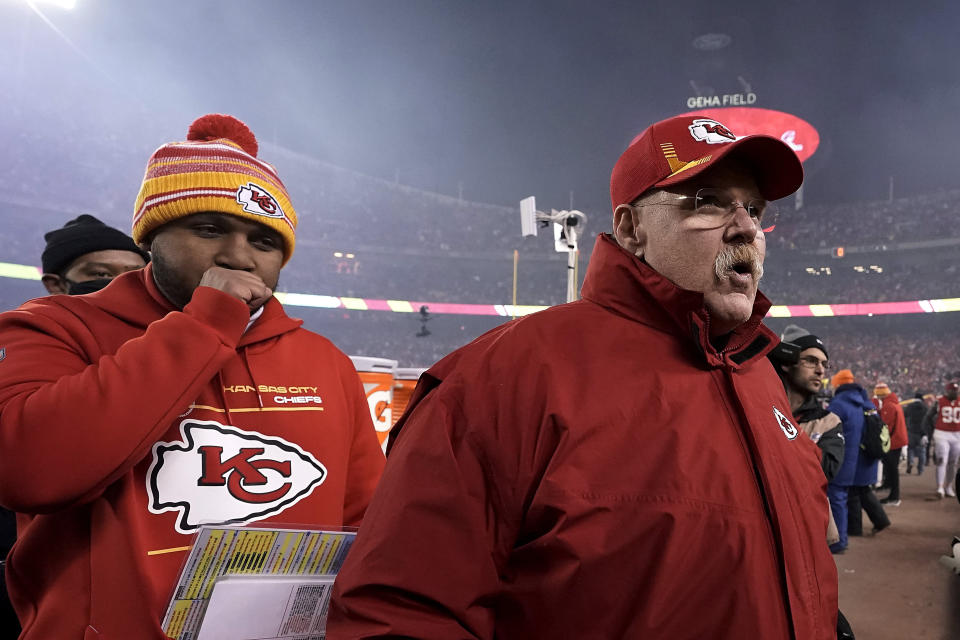 Kansas City Chiefs head coach Andy Reid, right, walks off the field after an NFL divisional round playoff football game against the Buffalo Bills, Sunday, Jan. 23, 2022, in Kansas City, Mo. The Chiefs won 42-36 in overtime. (AP Photo/Charlie Riedel)