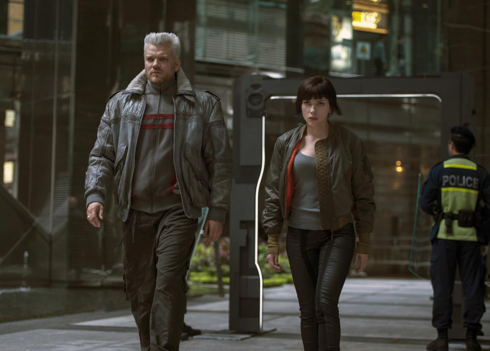 In this image released by Paramount Pictures, Pilou Asbaek, left, and Scarlett Johansson appear in a scene from, "Ghost in the Shell." (Jasin Boland/Paramount Pictures and DreamWorks Pictures via AP)