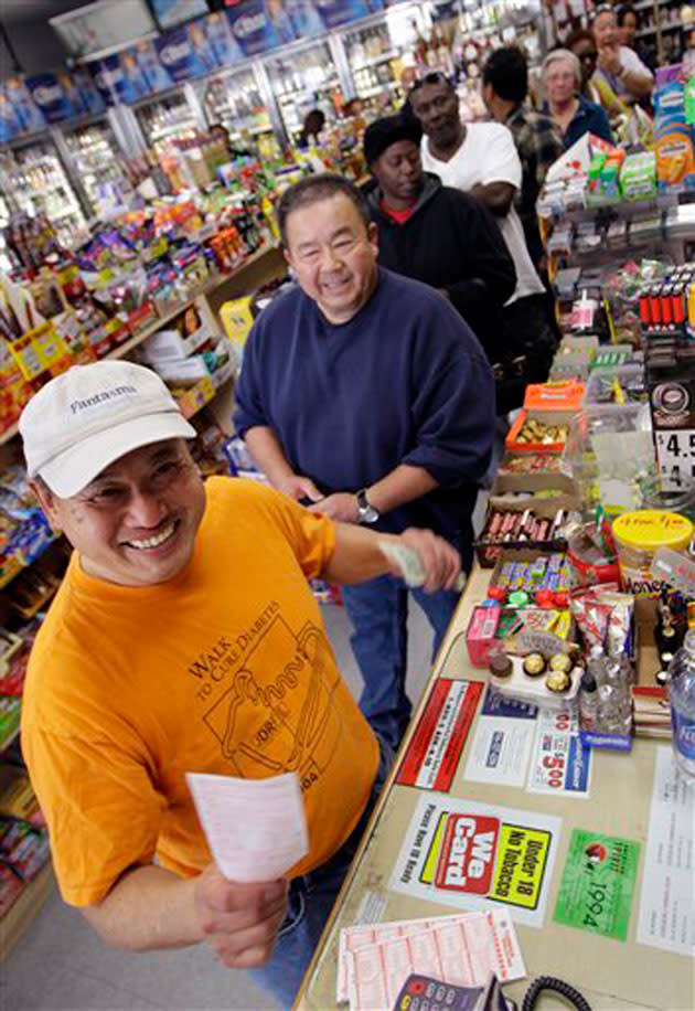 Shoppers wait in line for lottery tickets for the $540 million Mega Millions. AP