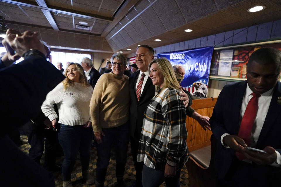 Former Secretary of State Mike Pompeo, center, poses for a photo with audience members after speaking at the West Side Conservative Club, Friday, March 26, 2021, in Urbandale, Iowa. (AP Photo/Charlie Neibergall)