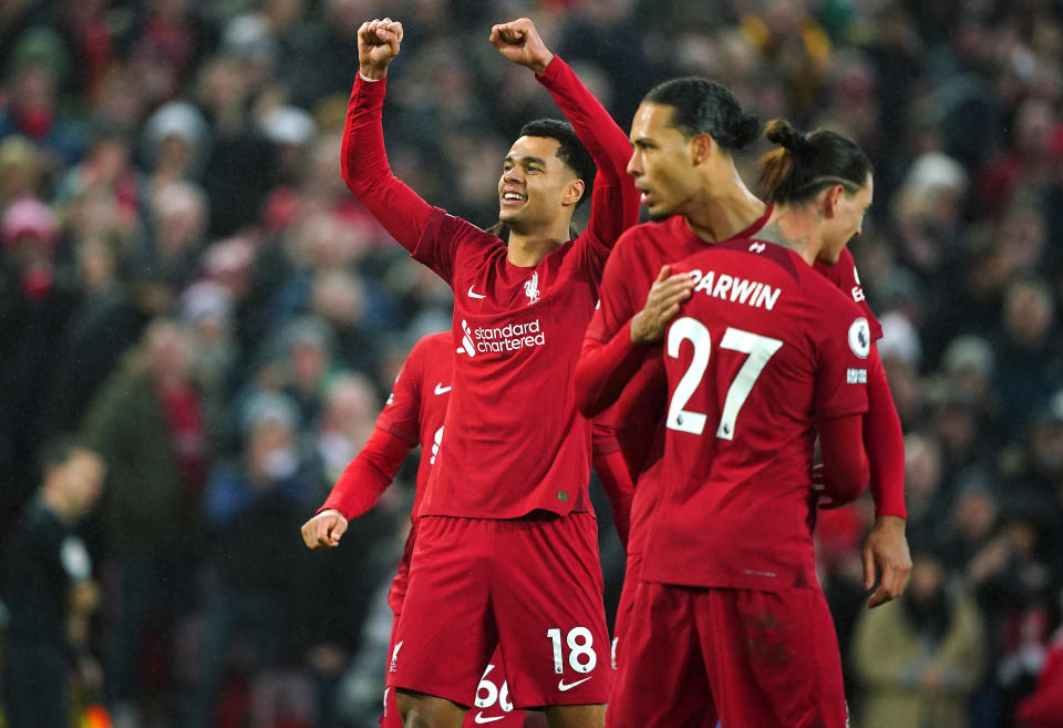 Pictured left, Liverpool's Cody Gakpo celebrates scoring his side's third goal of the game against Manchester United at Anfield. 