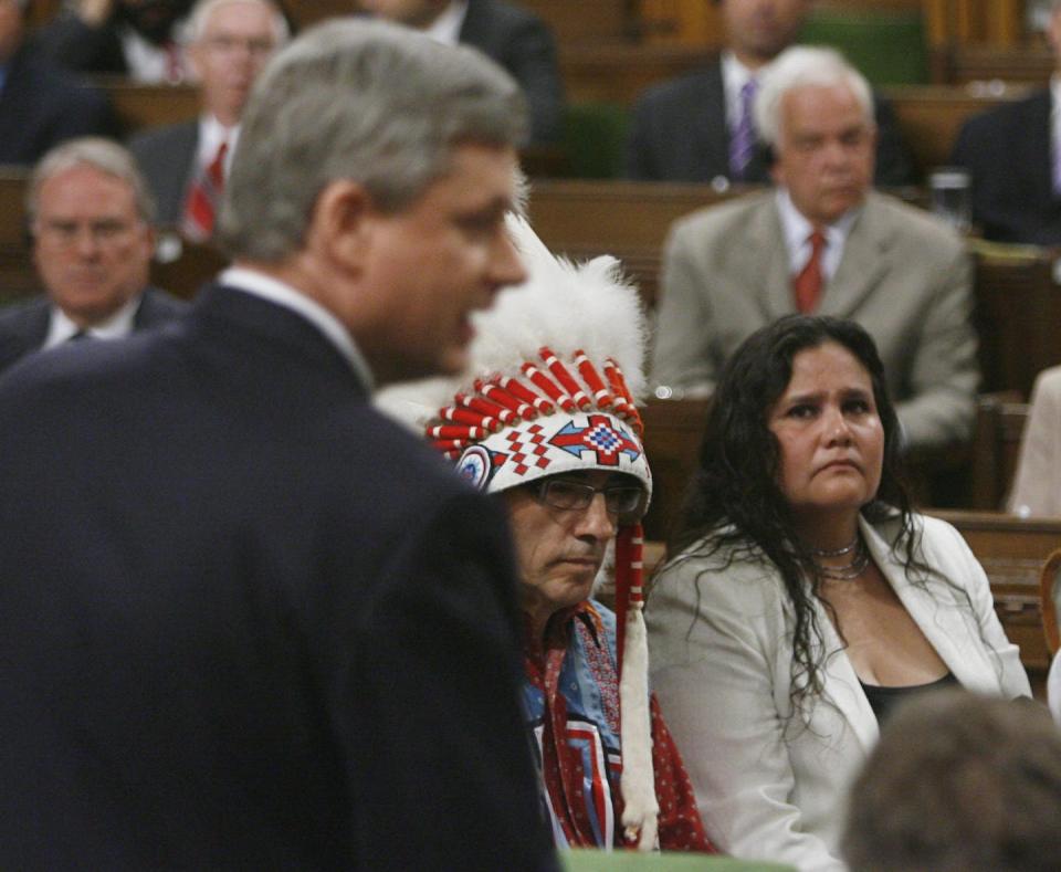 Phil Fontaine, then Assembly of First Nations chief (left), and Beverly Jacobs, then president of the Native Women’s Association of Canada (right), listen as Canadian Prime Minister Stephen Harper apologizes for Residential Schools in the House of Commons on Parliament Hill in Ottawa, June 11, 2008. THE CANADIAN PRESS/Tom Hanson