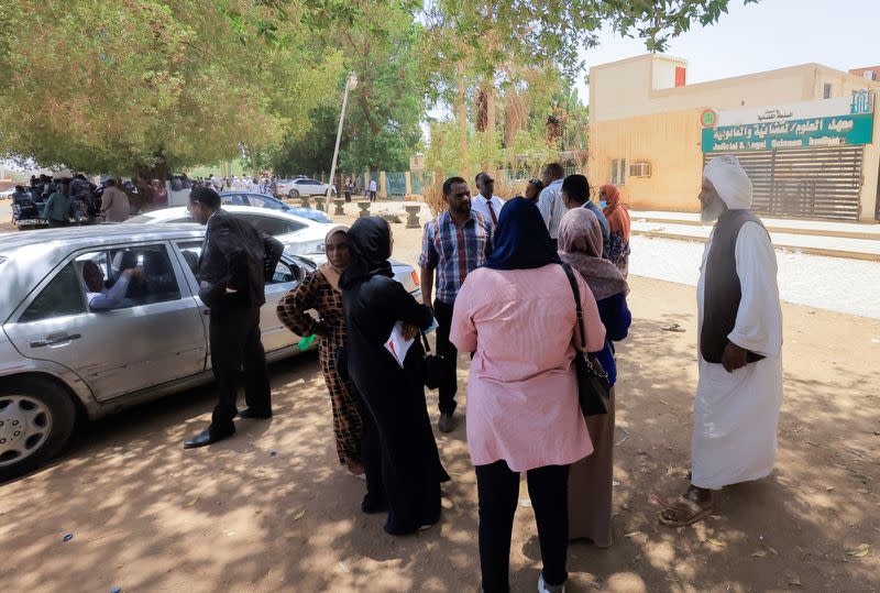 Demonstrators and families gather outside the court in Khartoum