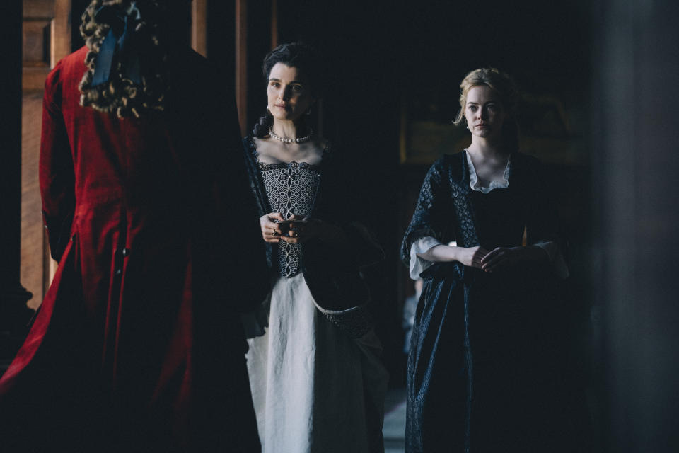 This image released by Fox Searchlight Films shows Rachel Weisz and Emma Stone, right, in a scene from the film "The Favourite." (Atsushi Nishijima/Fox Searchlight Films via AP)