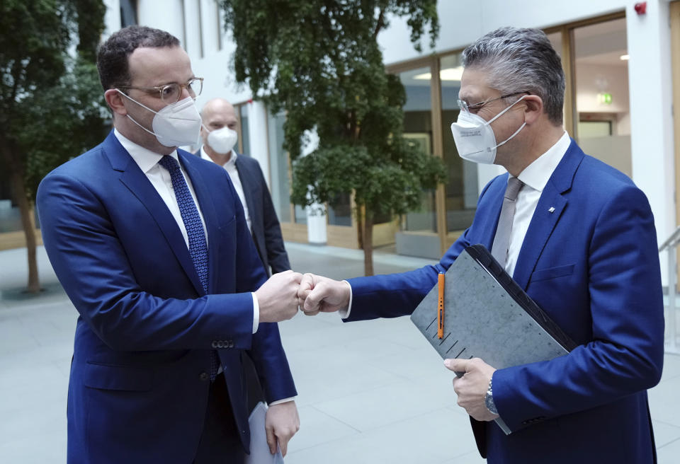 Jens Spahn, Executive Federal Minister of Health,left, and Lothar H. Wieler, President of the Robert Koch Institute (RKI), arrive for the press conference on the Corona pandemic in Berlin, Germany, Friday, Nov. 19, 2021. (Kay Nietfeld/dpa via AP)