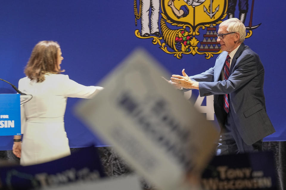 Wisconsin Gov. Tony Evers greats Lt. Gov.-elect Sara Rodriguez Wednesday, Nov. 9, 2022, in Madison, Wis., after beating businessman Tim Michels in Tuesday's election. (AP Photo/Andy Manis)