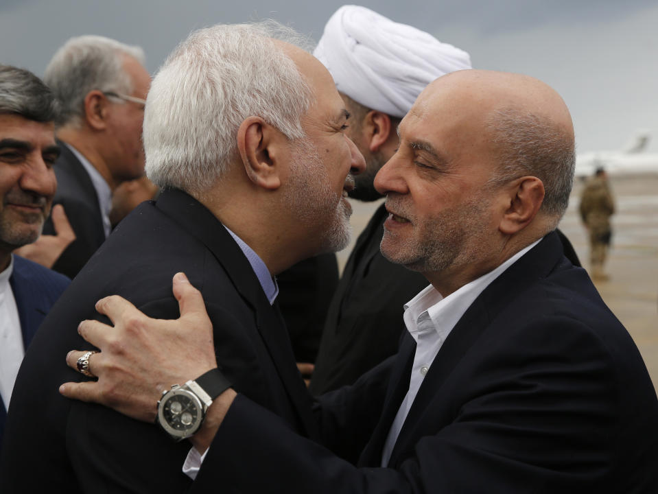 Iran's Foreign Minister Mohammad Javad Zarif, left, is greeted by Lebanese Hezbollah lawmaker, Amin Sherri, on his arrival at Rafik Hariri airport, in Beirut, Lebanon, Sunday, Feb. 10, 2019. Zarif said his country is ready to cooperate with the new Lebanese government, offering his country's support in all sectors. (AP Photo/Hussein Malla)