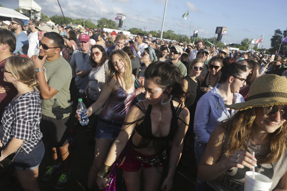 Samantha Gaboula of San Francisco, left, and Kelly Grace, of Philadelphia, dance to the music of Alanis Morissette at the Gentilly Stage at the New Orleans Jazz & Heritage Festival in New Orleans, Thursday, April 25, 2019. (AP Photo/Doug Parker)