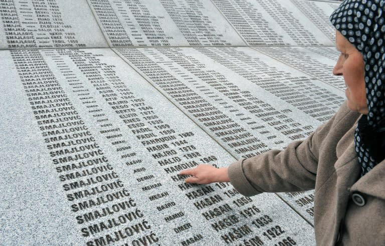 Bida Smajlovic, 64, survivor of July 1995 massacre in Srebrenica, stands at a memorial center in Potocari on March 24, 2016, pointing at the name of her husband engraved among names of other victims