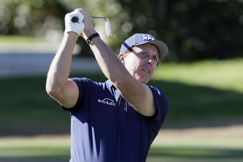 Phil Mickelson follows through on the fourth tee during the third round of The American Express golf tournament on the Stadium Course at PGA West in La Quinta, Calif., Saturday, Jan. 18, 2020. (AP Photo/Alex Gallardo)