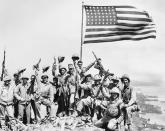 <p>A group of United States Marines celebrate their victory over the Japanese forces following the battle at Iwo Jima. </p>