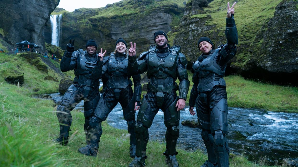  A shot from the Halo set showing the spartan actors waving and flashing peace signs 