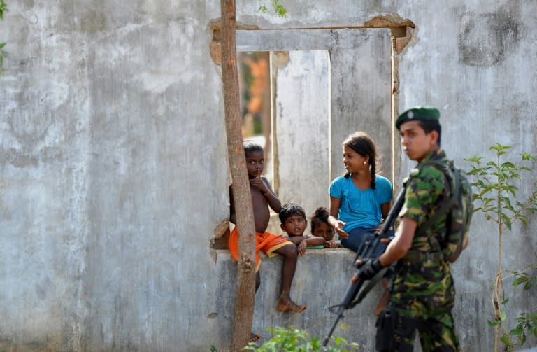 A soldier patrols as UN Secretary General Ban Ki-moon makes a visit to a resettlement village in Sri Lanka's Jaffna peninsula on September 2, 2016