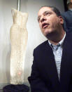 Peter Siegel, a New York memorabilia dealer, poses with the dress Marilyn Monroe wore to sing "Happy Birthday" to President John F. Kennedy, after buying the dress for $1,267,000 at auction at Christie's in New York on October 27. The sale smashed the record price paid for a dress at auction. Monroe was sewn into the form-fitting, flesh-toned dress minutes before her appearance at a May, 1962 birthday fete for Kennedy. Reuters