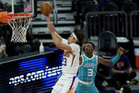 Phoenix Suns forward Cameron Johnson (23) shoots past Charlotte Hornets guard Terry Rozier (3) during the first half of an NBA basketball game, Wednesday, Feb. 24, 2021, in Phoenix. (AP Photo/Matt York)