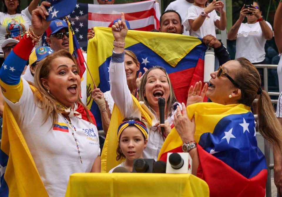 Speakers Helen Villalongo, left, president of the AMAVEX (Asociación Multicultural de Activistas Voz y Expresión) foundation, Nerlitt Torres, president of the Blanco Nieves Sierra foundation, and Adelys Ferro, executive director of Venezuelan American Caucus, lead the chant for democracy during a demonstration for the right to vote in the Venezuelan election. A group of about sixty people gathered at the former Venezuelan consulate in protest of their voting denial in the Venezuelan election on Sunday, July 28, 2024, in Miami, Florida.