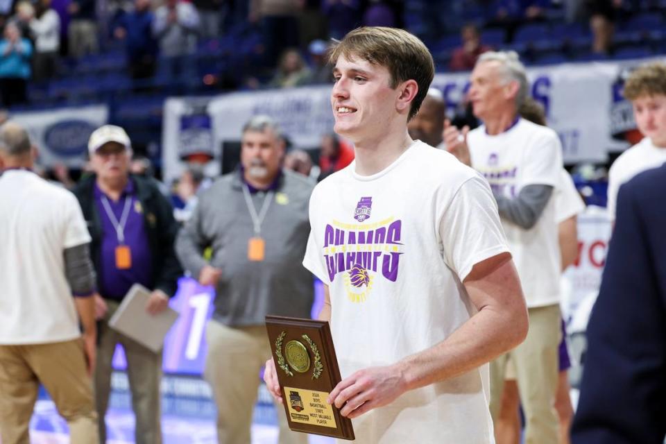 Lyon County star Travis Perry holds his MVP award after winning the boys state championship on Saturday night in Rupp Arena.